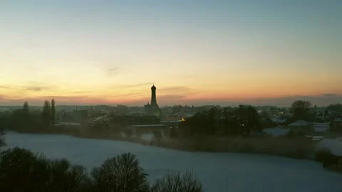 Diagonal drone ascent over snowy countryside and village in Bavaria Stock-Footage 232627929