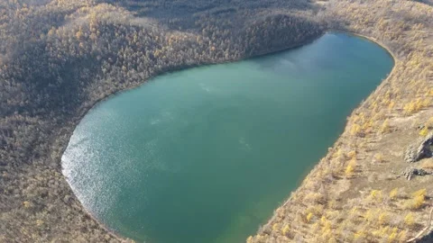 Diagonal Drone Push Toward Turquoise Crater Lake Autumn Forest Stock Footage 330234737