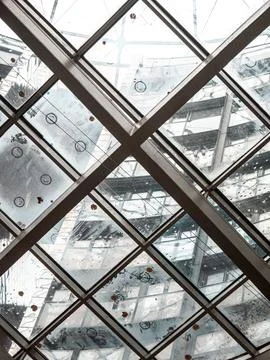 Diagonal glass atrium grid reflections Фото