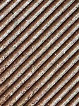 Diagonal Grooved Concrete Surface Texture with Brown and White Stripe Pattern Stock Photos