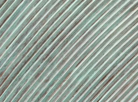 Diagonal grooved texture with weathered green and brown stripes 库存照片
