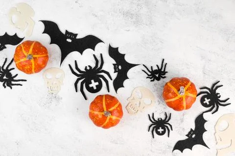 Diagonal halloween flat lay background with spooky decorations. Pumkins,skull Stock Photos