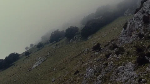 A diagonal hill with clouds hitting the side Stock Footage 88713675