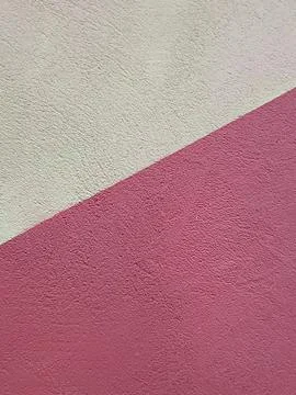 Diagonal intersection of light grey and magenta textured surfaces with grey wall Stock Photos