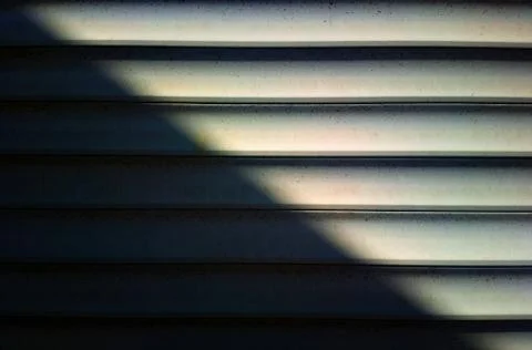 Diagonal light ray on horizontal siding texture backdrop 스톡 사진
