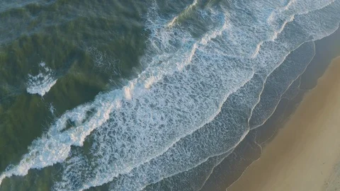 Diagonal Ocean Waves Crashing on Sandy Beach Shoreline Aerial View Stock Footage 109415619