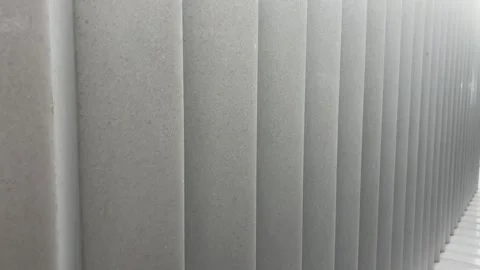 Diagonal Pan Shot of Off-white Vertical Pleated Wall Texture Close Up Stock Footage 332522163