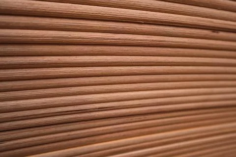 Diagonal pattern of cylindrical wooden rods or bed frame slats close-up. Stock Photos