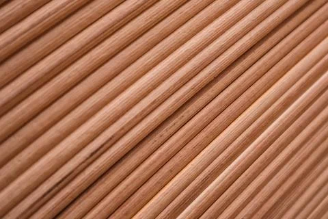 Diagonal pattern of cylindrical wooden rods or bed frame slats close-up. Stock Photos