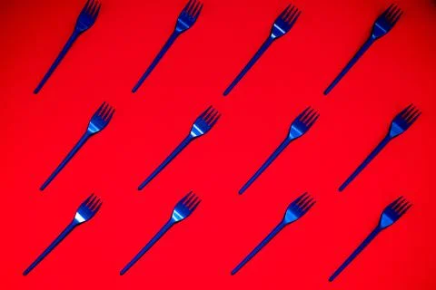 Diagonal pattern with plastic spoons and forks Stock Photos
