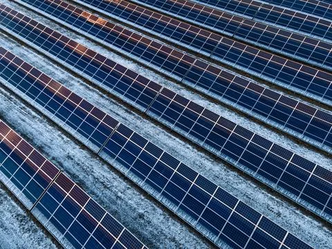 Diagonal Pattern of Solar Panels with Snow, Aerial View Stock Photos