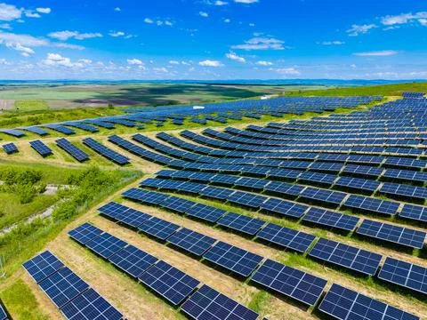 Diagonal perspective of solar rows leading toward horizon, sweeping arrangeme Stock Photos