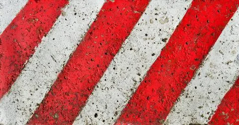 Diagonal red-white lines Diagonal red-white lines paint pattern on a rough... Stock Photos