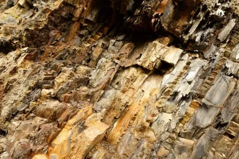 Diagonal rock material texture. Macro of old mountain stones pattern background Stock Photos