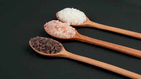 Diagonal Rotating Three Gourmet Salts On Wooden Spoons Stockbeeldmateriaal 331845344
