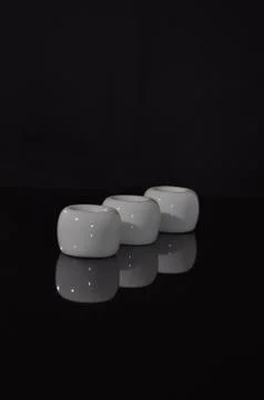 Diagonal row of white ceramic cylinders Stock Photos