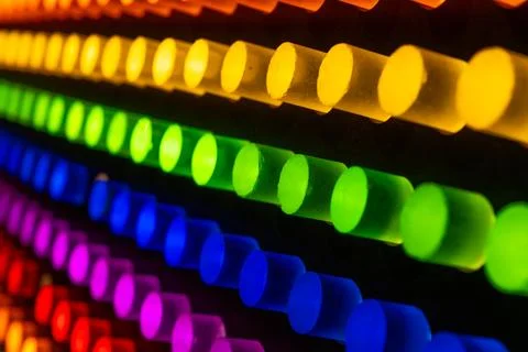 Diagonal Rows of Glowing Neon Cylinders in Rainbow Colors Stock Photos
