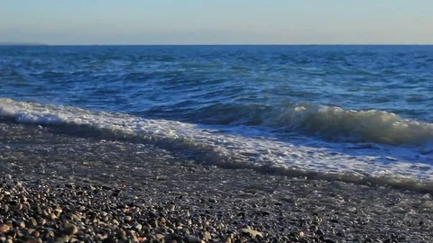 Diagonal sea blue water waves on pebble coast Stock Footage 76326074