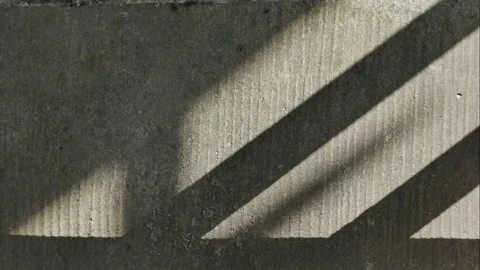 Diagonal shadows cast by the sun on a concrete surface. Stock Footage 329906458