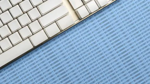 Diagonal split-screen concept showing a retro white keyboard next to blue b.. Stock Photos