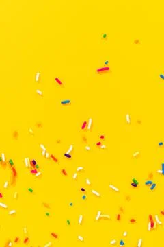 Diagonal sprinkle layout over yellow background Stock Photos