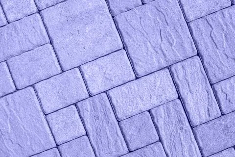 Diagonal street pavement pattern from directly above toned in very peri color Stock Photos