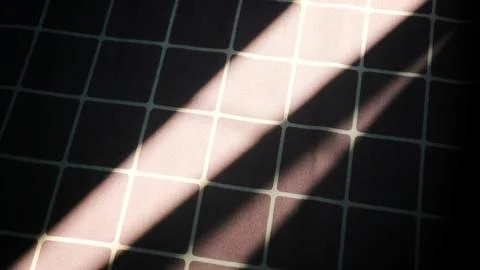 Diagonal sunlight and shadow on checkered fabric Stock Photos