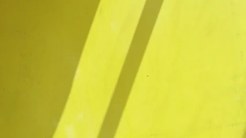 Diagonal Sunlight Shadows on Bright Yellow Wall Abstract Background Stock Footage 346281645