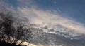 Diagonal sunset clouds timelapse over city with half moon HD Footage