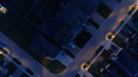 Diagonal Top Down View Of House Rooftops At Night Drone Aerial Stock Footage