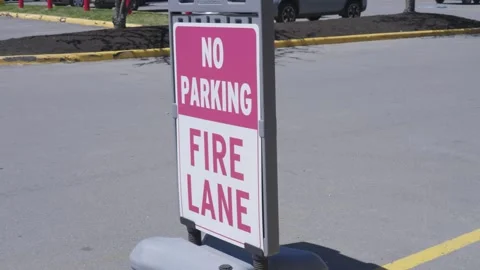 Diagonal View of Fire Lane Stand-Up Sign in Parking Lot Stock Footage 291938521