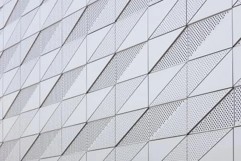 Diagonal view of light surface with geometric pattern with round openings 写真素材