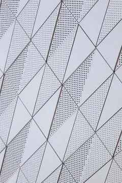 Diagonal view of white surface with geometric pattern with round openings 스톡 사진