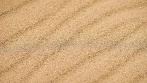 Diagonal waves of sand. Sandy texture background. Photos