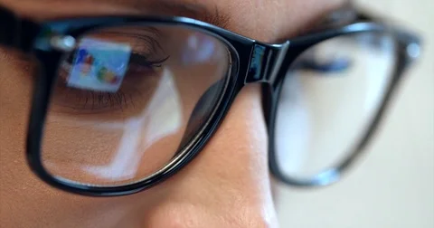 The diagrams and draphics reflection in the spectacles of the businesswoman Stock Footage 82644203