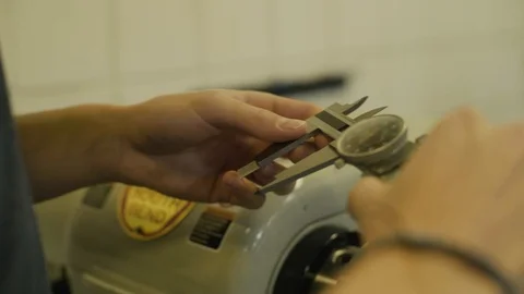 Dial caliper taking measurement of part Stock-Footage 103336983