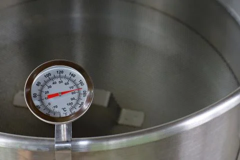 Dial Thermometer in Heating Water Stock Photos