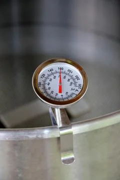 Dial Thermometer in Heating Water Stock Photos