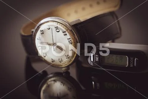 Dial of a wristwatch reflected on a table Stock Photos