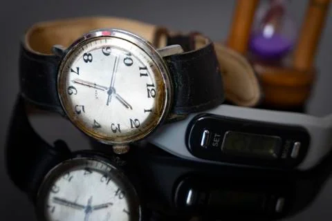 Dial of a wristwatch reflected on a table Stock Photos