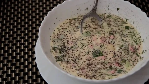 Dialed with a spoon from a white plate of cold soup Stock Footage 123624056