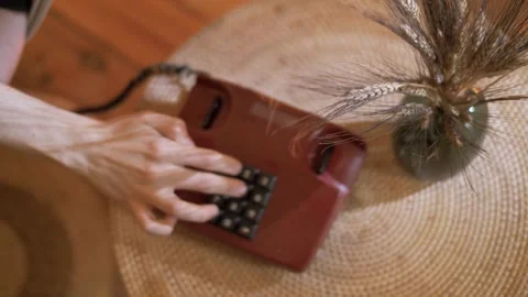 Dialing a number on a push-button landline corded telephone Stock Footage 245991967