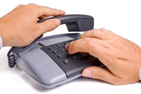Dialing a phone number on the push-button phone Stock Photos