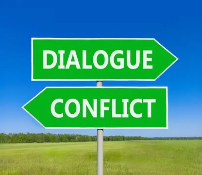 Dialogue instead conflict symbol. Concept words Dialogue and Conflict on be.. Foto stock