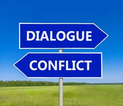 Dialogue instead conflict symbol. Concept words Dialogue and Conflict on be.. Foto stock