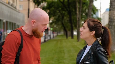 Dialogue on street between a young guy and a girl. Positive conversation, smiles Video stock 139002420