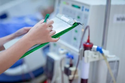 Dialysis nurse are checking dialysis machine before hemodialysis replacement  Stock Photos