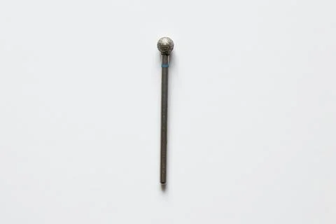 A diamond ball-shaped drill bit on a white background for cuticle treatment,  Stock Photos