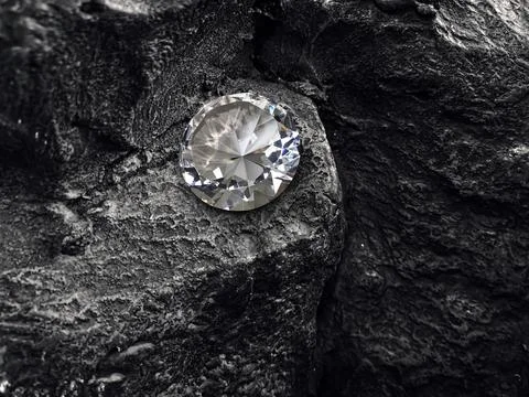 Diamond on black coal background Stock Photos