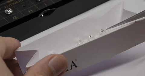 Diamond color grading with master stones. Gemstone laboratory. Gemologist checks Stock Footage 258166107